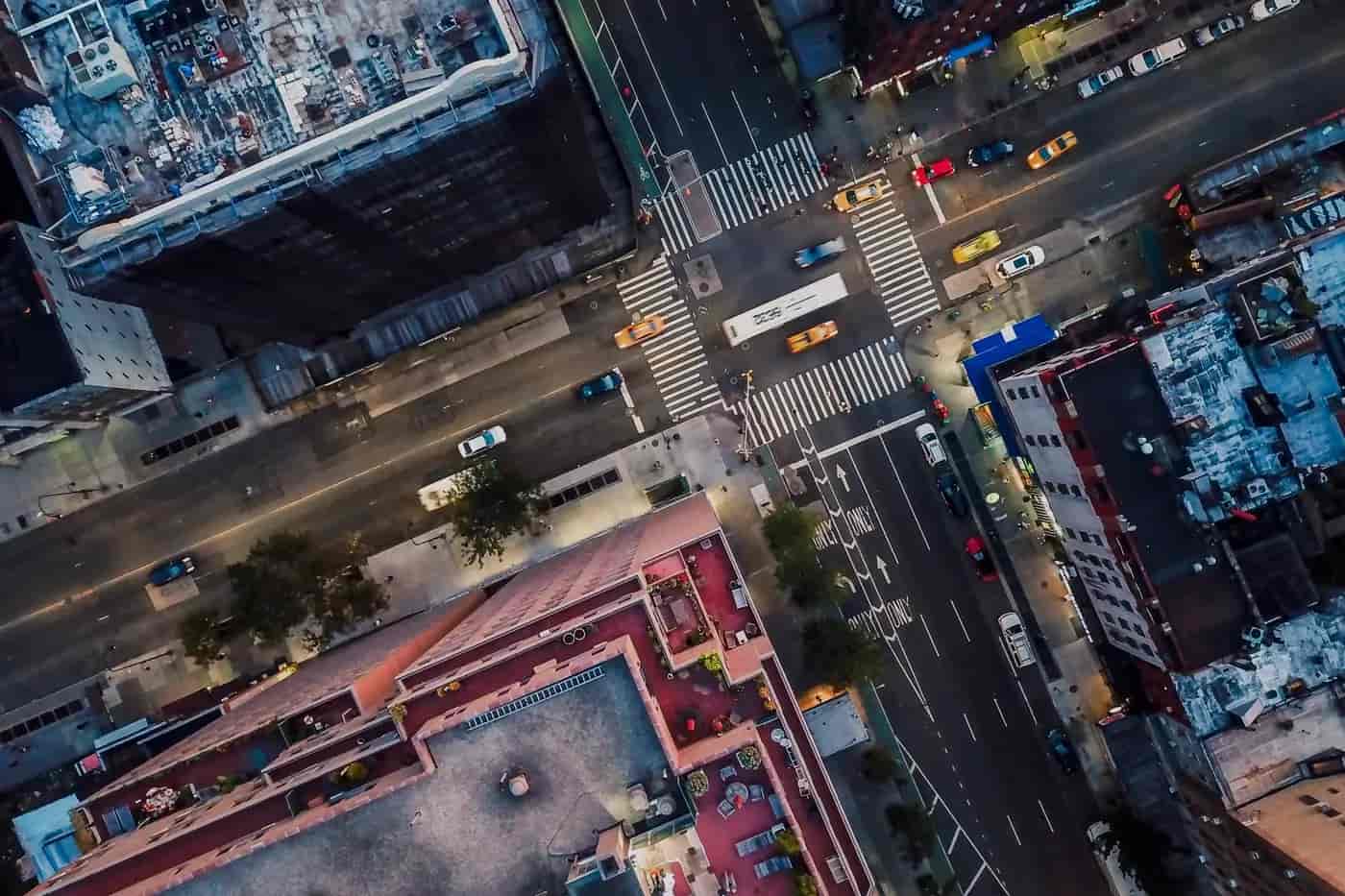 aerial view of busy city intersection with traffic and buildings representing urban infrastructure and digital connectivity
