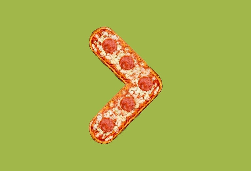 Creative food art showing an arrow made of pepperoni pizza