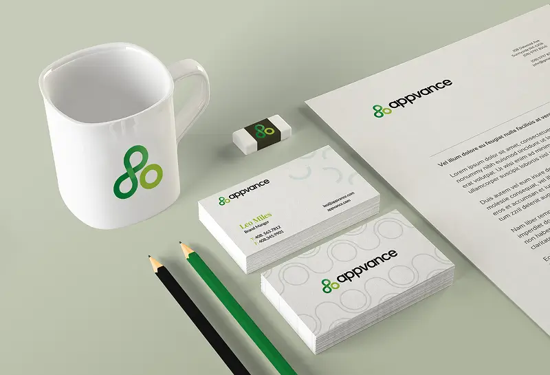 Appvance branded stationery set with mug, business cards, letterhead, and pencils in green and black color scheme