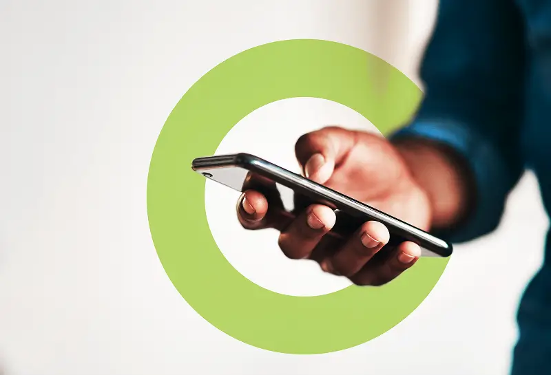 Hand holding a smartphone with green circular overlay, representing digital technology and user interaction