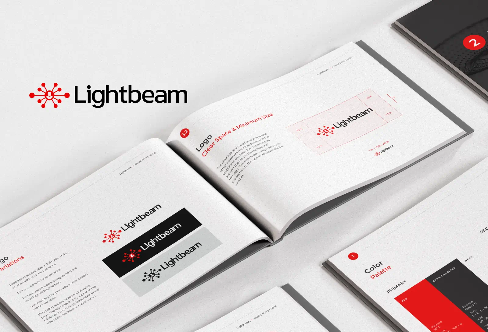 Lightbeam brand guidelines booklet open on a desk, showing logo usage, color palette, and design specifications.