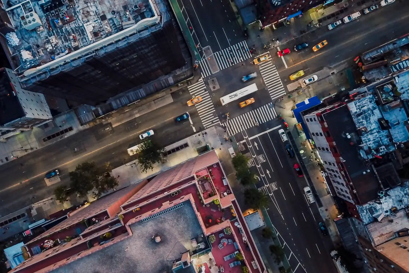 aerial view of busy city intersection with traffic and buildings representing urban infrastructure and digital connectivity