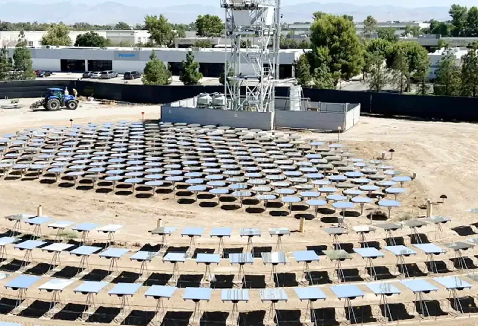 Heliogen heliostat field with reflective mirrors surrounding a central receiver tower at an industrial facility.