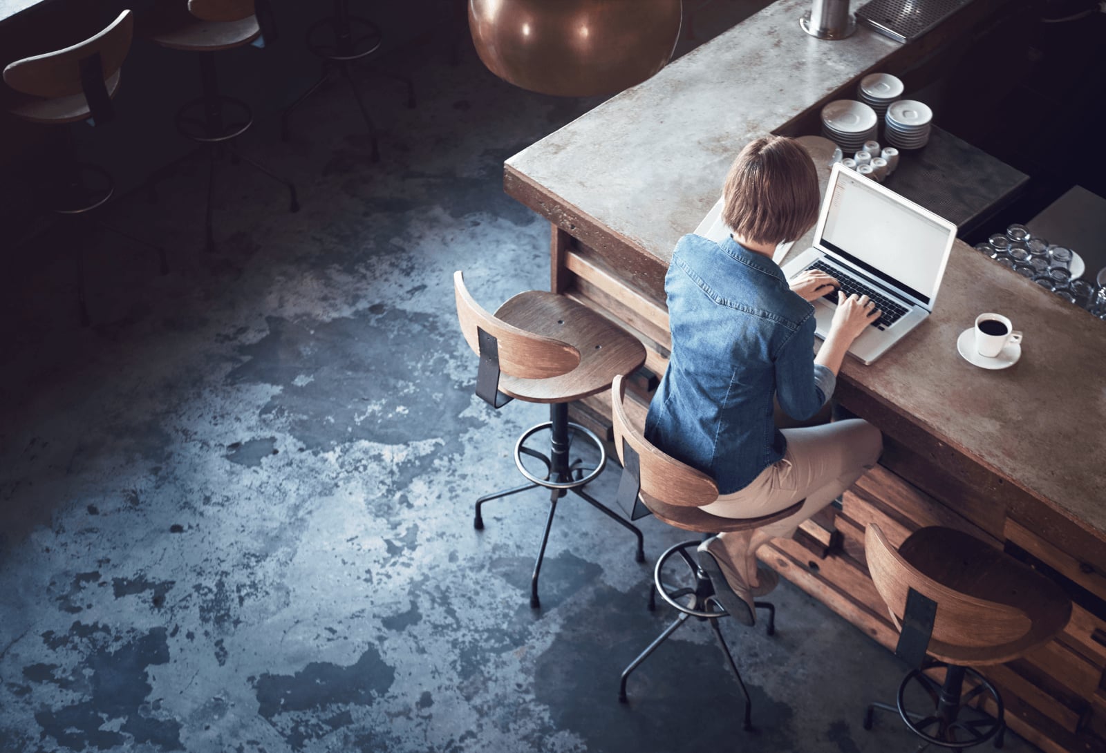 Person using laptop in a modern workspace for SaaS development and software collaboration